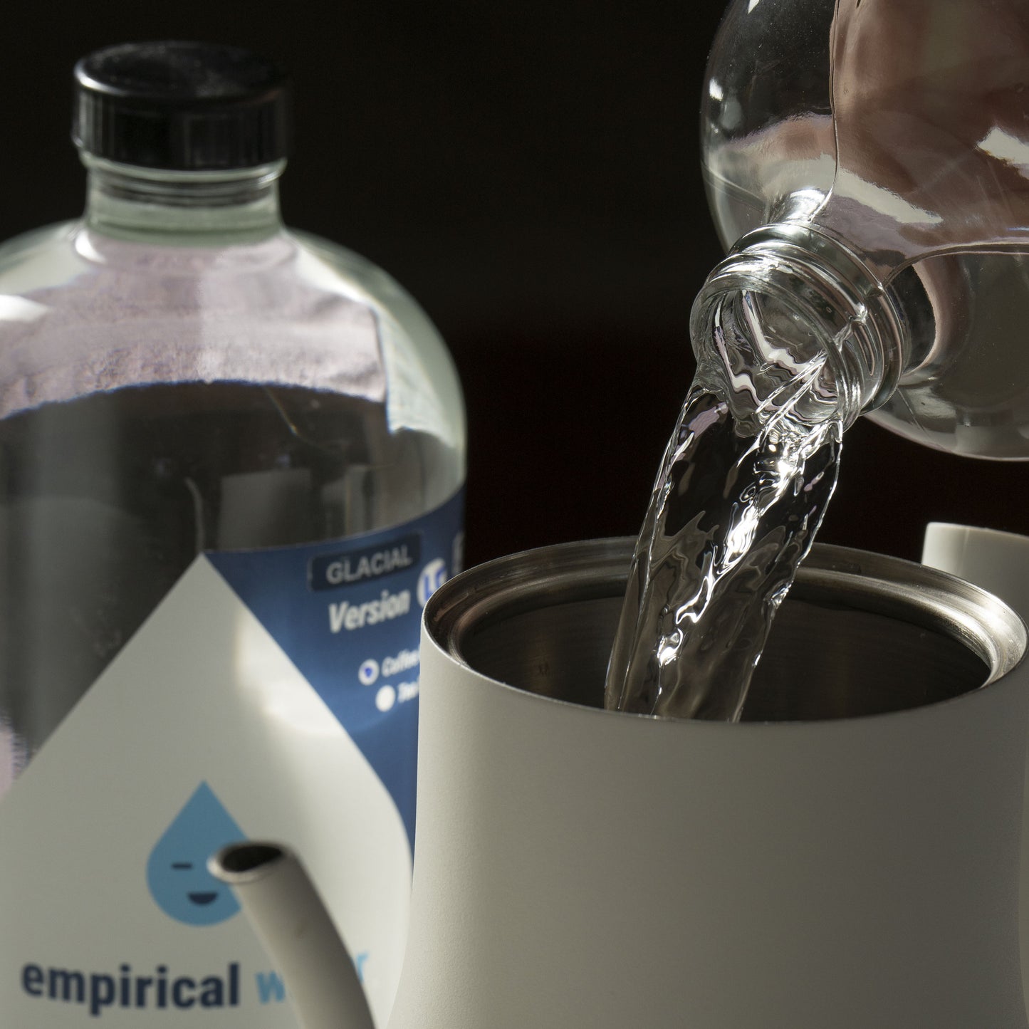 close up of pouring the best water for coffee into a kettle